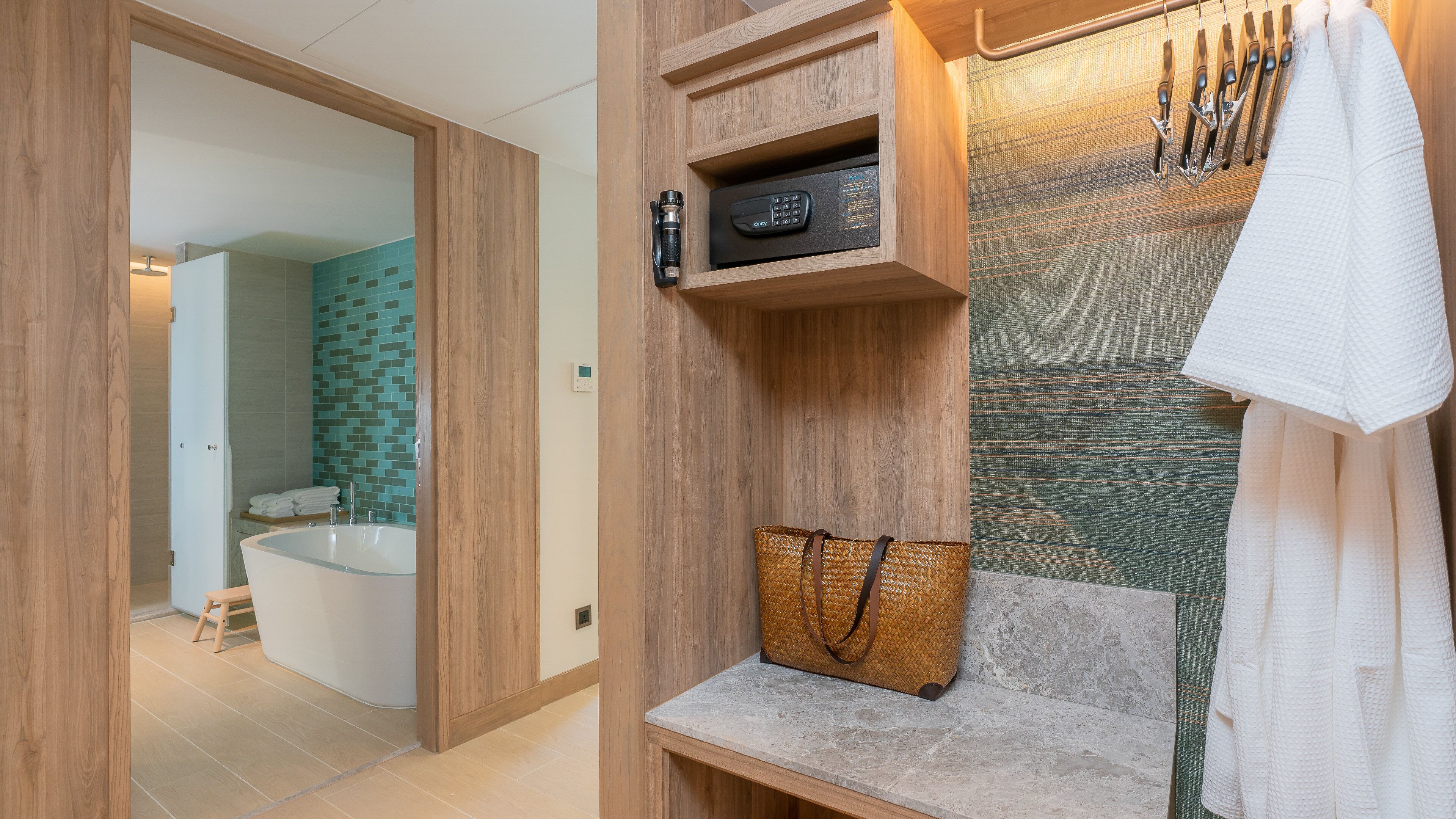 A bathroom with a wooden vanity, a towel rack, and a small basket.