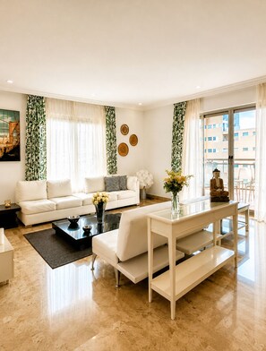 A modern living room with a sofa, coffee table, and a decorative vase.