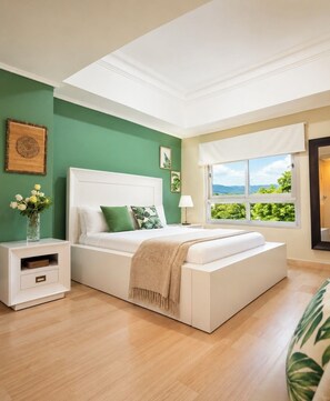 A bedroom with a bed, bedside table, and a window with a view.