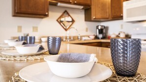 A kitchen with wooden cabinets, a microwave, and a coffee maker. - Amazing Lakefront Pool On Coveted Horseshoe Bend! (Four Seasons)