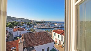 A coastal town with a historic fort, boats, and traditional buildings. - Mavrella Bozcaada (Bozcaada)
