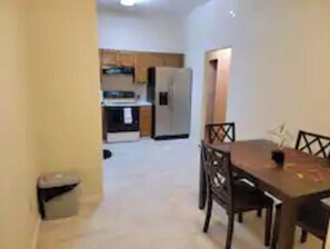 Compact living space with a kitchenette, dining table, and comfortable seating.
