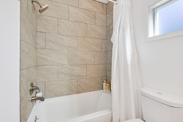 A bathroom with a bathtub, shower, and toilet. - 3BR/2BA House-AC- Parking- Light Rail (Relist- supper host) (Seattle)