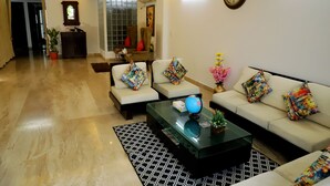 A modern living room with a sofa set, a coffee table, and a globe.