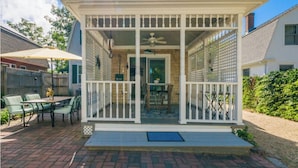 A covered patio with a table and chairs, a ceiling fan, and a view of the backyard. - Right on the Cape Cod Canal and bike path! (Bourne)
