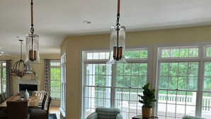 A spacious kitchen with a large island, two hanging pendant lights, and a view of the outdoors through large windows. - Close to the beach! A great multi family home with loads of ammenties.  (Bethany Beach)