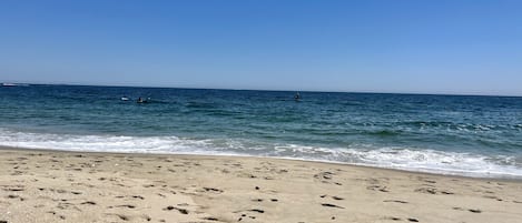 Una playa cerca, sillas reclinables de playa, toallas de playa