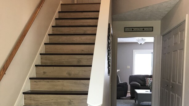 A wooden staircase with white handrails leading to a landing. - Residential home all hardwood floor, ten minutes from downtown. No pets aloud. (Lexington)