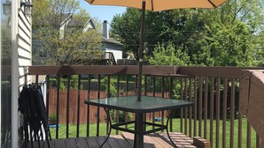 A wooden deck with a table and an umbrella. - Residential home all hardwood floor, ten minutes from downtown. No pets aloud. (Lexington)
