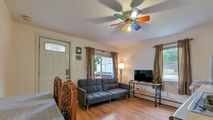 A living room with a sofa, TV, and a ceiling fan. - Clean & Cozy 1BR Apt#6 w/Full Kitchen & Private Bath (Ellsworth)