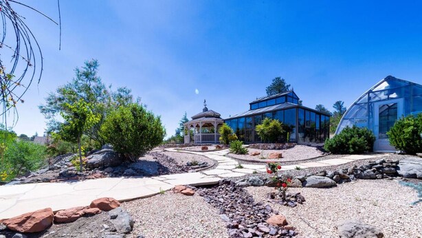 A modern house with a glass greenhouse, a gazebo, and a stone pathway. - *Gas Fireplace *Spacious *Family Friendly *Hot Tub (Prescott)