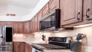 A modern kitchen with stainless steel appliances, wooden cabinets, and granite countertops. - *Gas Fireplace *Spacious *Family Friendly *Hot Tub (Prescott)