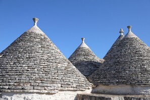 A row of stone-roofed buildings with conical roofs.
