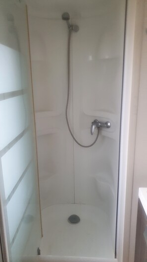 Shower, hair dryer, towels, toilet paper
