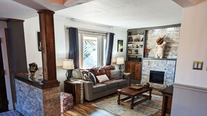 A cozy living room with a fireplace, a sofa, and a coffee table. - Enjoy relaxing comfort in this uniquely designed home - 5min from Frontier Park (Cheyenne)