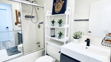 Combined shower/tub, hair dryer, towels, soap