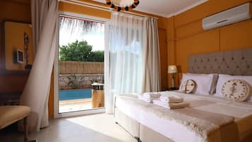 A hotel room with a bed, a bedside table, a lamp, a window with curtains, and a view of a swimming pool.