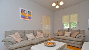 A living room with two grey sofas, a white coffee table, and a painting on the wall. - House 2174/55597 (Istria - Rovinj), 600m from the beach (Rovinj)