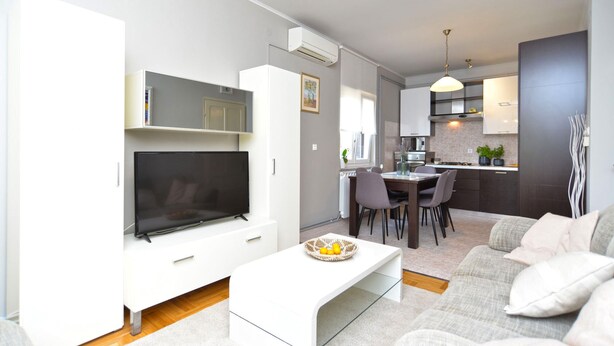 A modern living room with a flat-screen TV, a white coffee table, and a grey sofa. - House 2174/55597 (Istria - Rovinj), 600m from the beach (Rovinj)