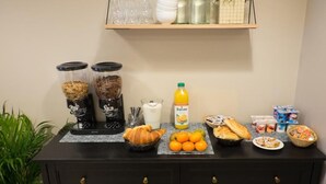 A breakfast buffet with various food items and beverages on a counter. - Hôtel De La Gare (Villeneuve-Saint-Georges)