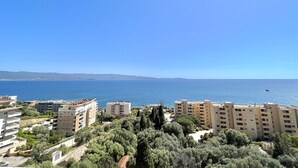 A coastal residential area with multi-story buildings, a clear blue sky, and a view of the sea. - 3-room apartment, 2 bedrooms, sleeps 4 in Ajaccio (Ajaccio)