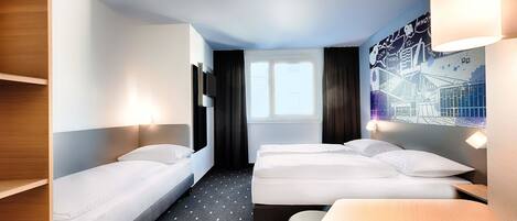 Habitación de hotel con dos camas individuales, una mesita, un sofá, un televisor y una ventana con cortinas.