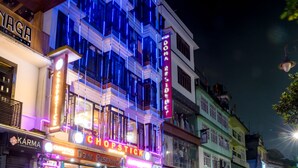 A multi-story building with illuminated signage for 'Doma Residency' and 'Chopstick'. - Doma Residency (Gangtok)