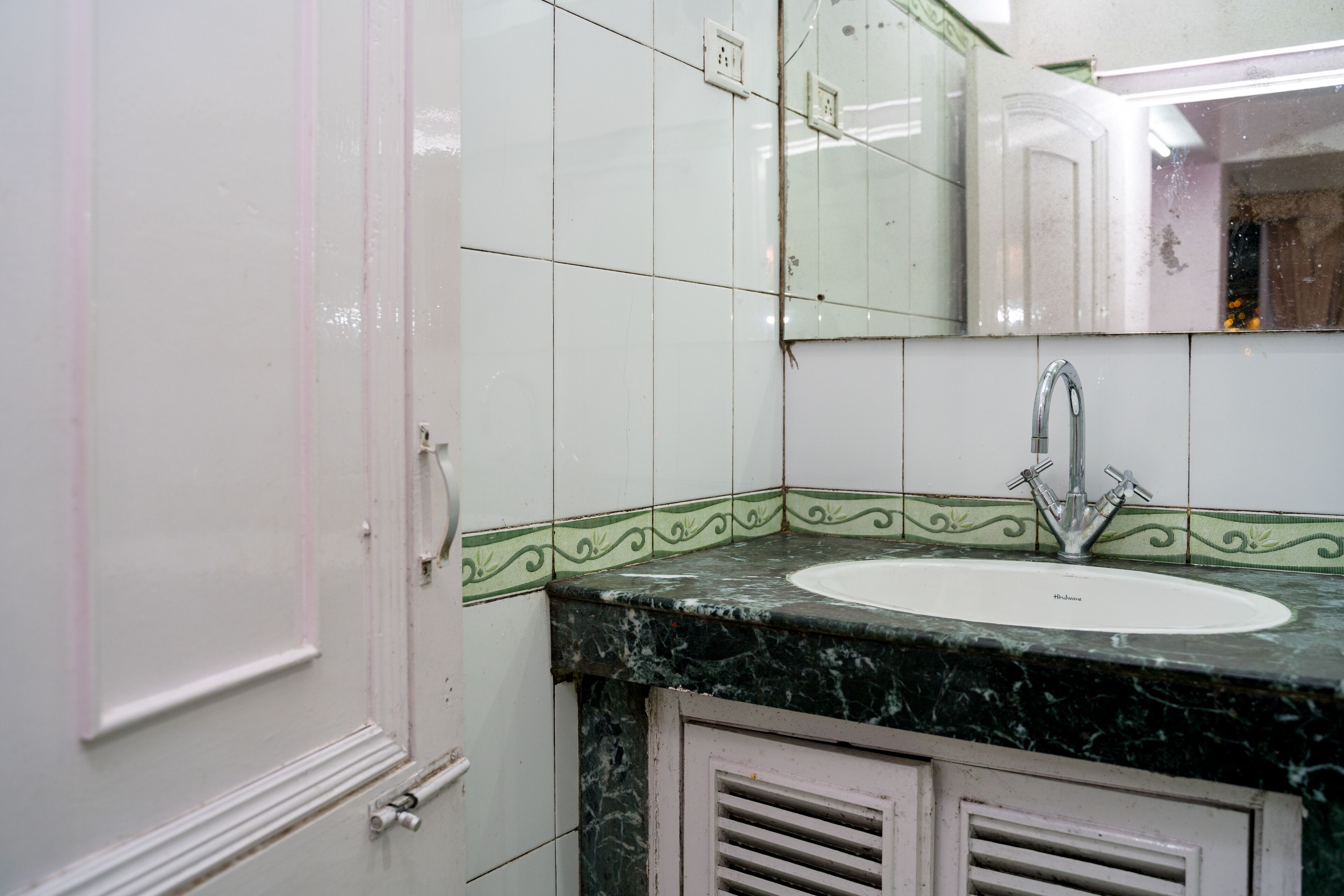 A bathroom with a sink, mirror, and vanity cabinet.