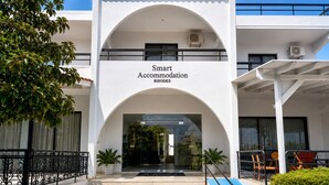 A building with a sign reading 'Smart Accommodation RHODES' and a covered entrance with steps leading up to it. - Smart Accomodation Rhodes by GHH (Rhodes)