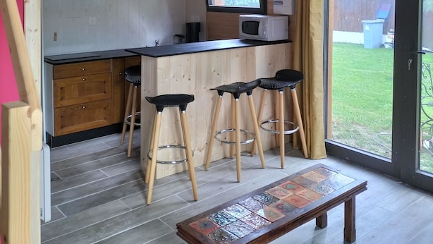 Eine Küche mit Holzausstattung, Barhocker und einer Bank.