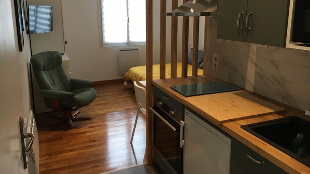A compact kitchen with a wooden countertop, a built-in oven, and a sink. - Downtown studio*** with outdoor parking and private, secure bike storage. (Bagnères-de-Bigorre)