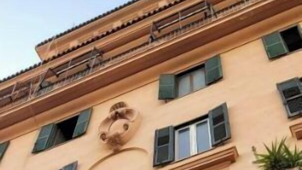 A multi-story building with classical architectural features, including ornate columns and decorative moldings.