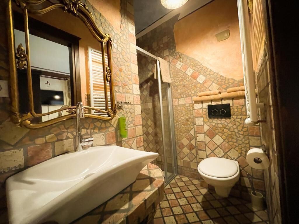 A bathroom with a bathtub, toilet, and shower.