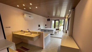 A modern bathroom with a double sink vanity, a large mirror, and a ceiling-mounted air conditioner. - Front sea Mansion With Pool Maceio Paripueira (Paripueira)