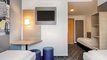 A modern hotel room with two beds, a flat-screen TV mounted on the wall, and a small table.