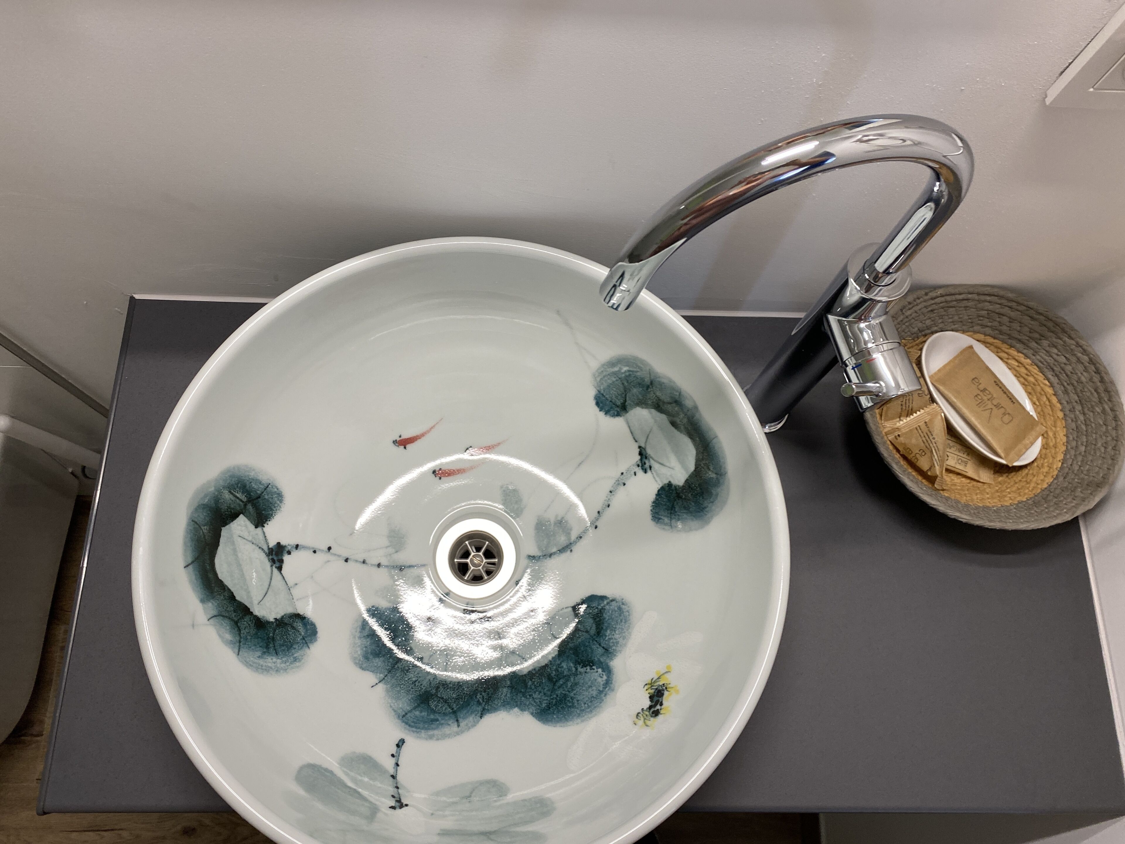 A bathroom sink with a modern faucet and a decorative bowl.