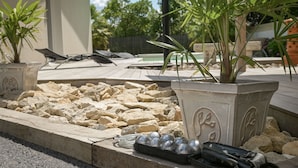 A patio area with a pool, outdoor furniture, and a potted plant. - Vacation Villa "Villa Teny La Teste Arcachon" with Pool, Garden, and Terrace (La Teste-de-Buch)