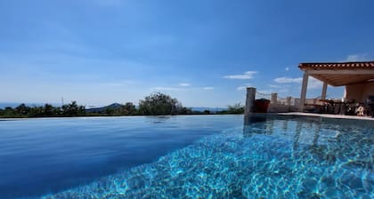 New villa with 2 pools & perfect sea view on a quiet green hill 5 min from beach