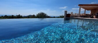 New villa with 2 pools & perfect sea view on a quiet green hill 5 min from beach
