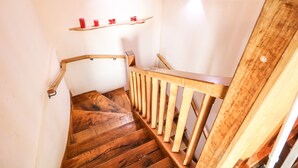 A wooden staircase with a handrail and a wooden handrail on the right side. - The Upper Room (Ballymena)