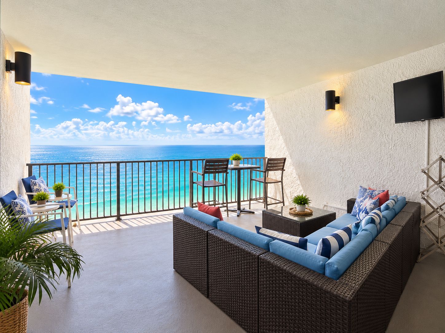 Gulf-Front Balcony — Enjoy stunning Gulf views, comfortable seating, outdoor dining, and a TV.