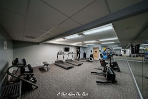 A gym with treadmills, weight machines, and exercise balls. - Seasational Escape!  Amazing Beachfront Condo/Covered Balcony, BEACH SER, Pool (Panama City Beach)