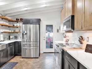 Enjoy cooking in this well-equipped kitchen with a double-door refrigerator, oven, and microwave.