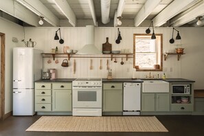 Enjoy cooking in this well-equipped kitchen with a refrigerator, oven, dishwasher, and microwave.