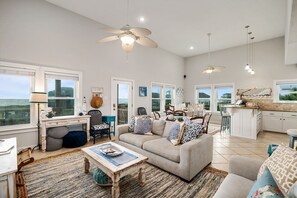 Relax in this stylish living area with a sofa, coffee table, and kitchen bar.
