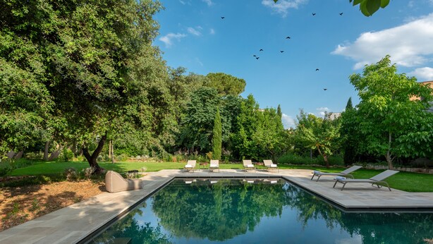 A swimming pool with lounge chairs and a reflection of trees. - Palazzo Donna Elisabetta -Guest House (Manduria)