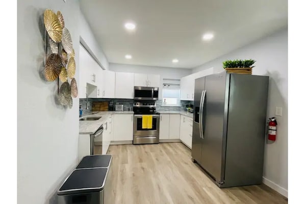 Enjoy cooking in this well-equipped kitchen with a refrigerator, oven, and dining area.