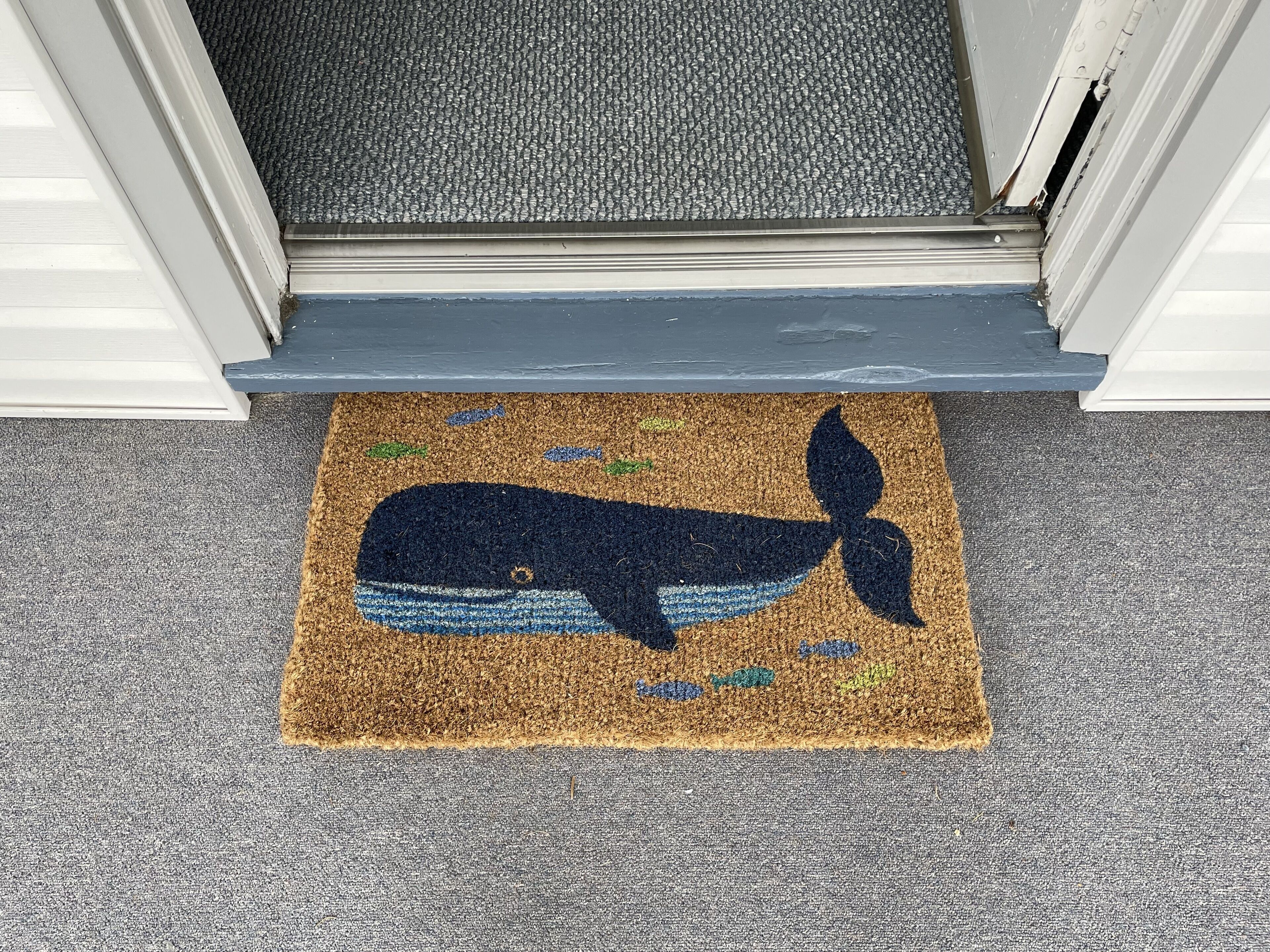 A doormat with a whale design.