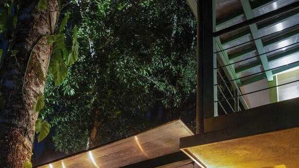 An outdoor covered area with hanging plants, a hammock, and a metal railing. - Casa del Bosque, La Fortuna, Costa Rica (La Fortuna, San Carlos)