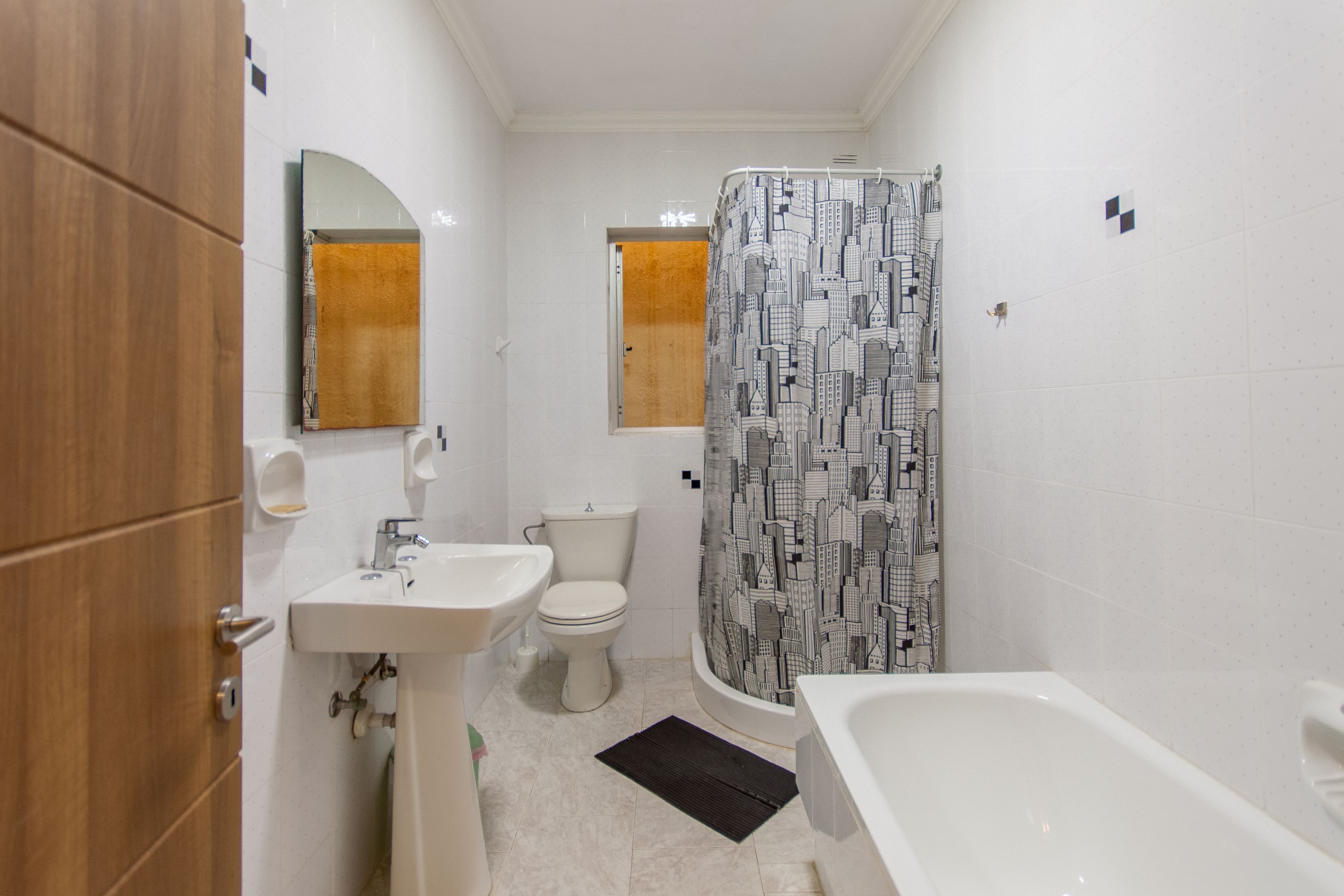 A bathroom with a sink, toilet, and bathtub.